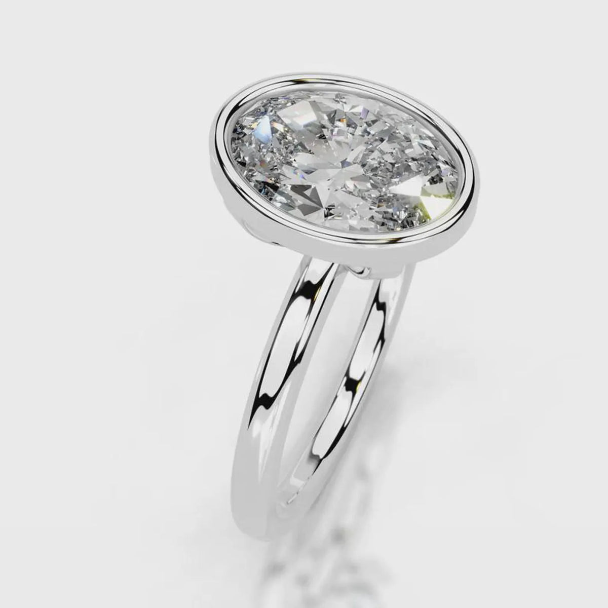 Angled top view of a 4 CT oval cut lab grown diamond bezel setting in white gold.