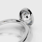 Architectural open basket detail under a 4 CT oval lab diamond bezel setting in white gold.
