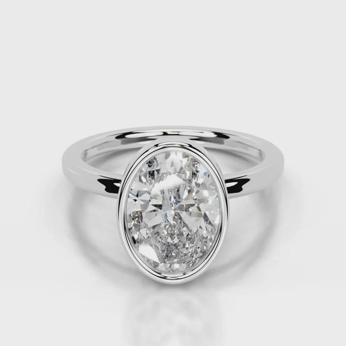 Front top-down view of a 4 CT oval lab grown diamond engagement ring in white gold bezel.
