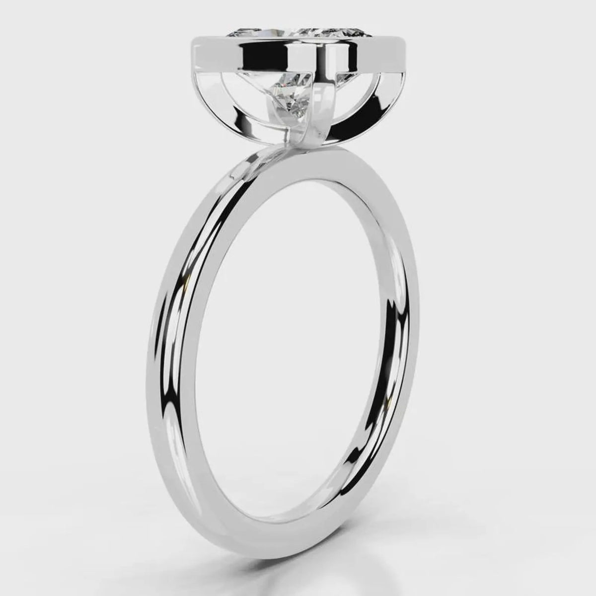 Side profile view of a 4 CT cushion cut lab grown diamond bezel ring in white gold.