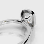 Detail view of the open gallery structure under a 4 CT cushion lab diamond in white gold bezel.