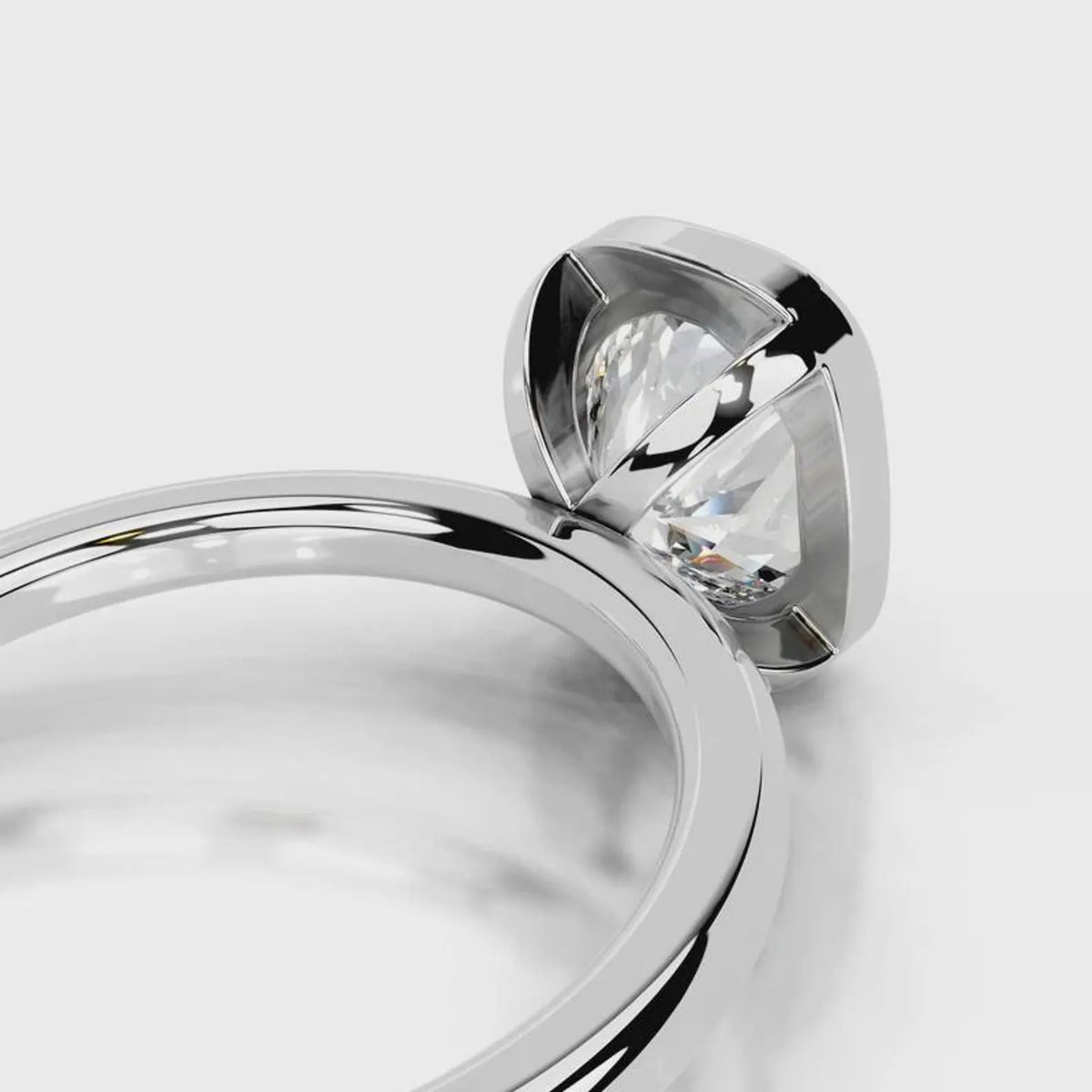 Detail view of the open gallery structure under a 4 CT cushion lab diamond in white gold bezel.