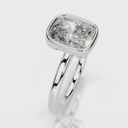 Angled top view of a 4 CT cushion cut lab diamond bezel engagement ring in white gold.
