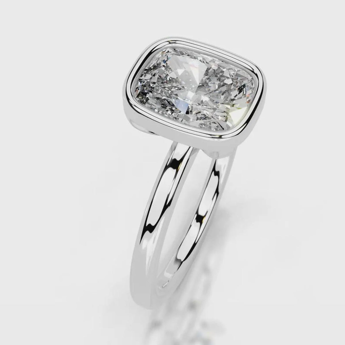 Angled top view of a 4 CT cushion cut lab diamond bezel engagement ring in white gold.