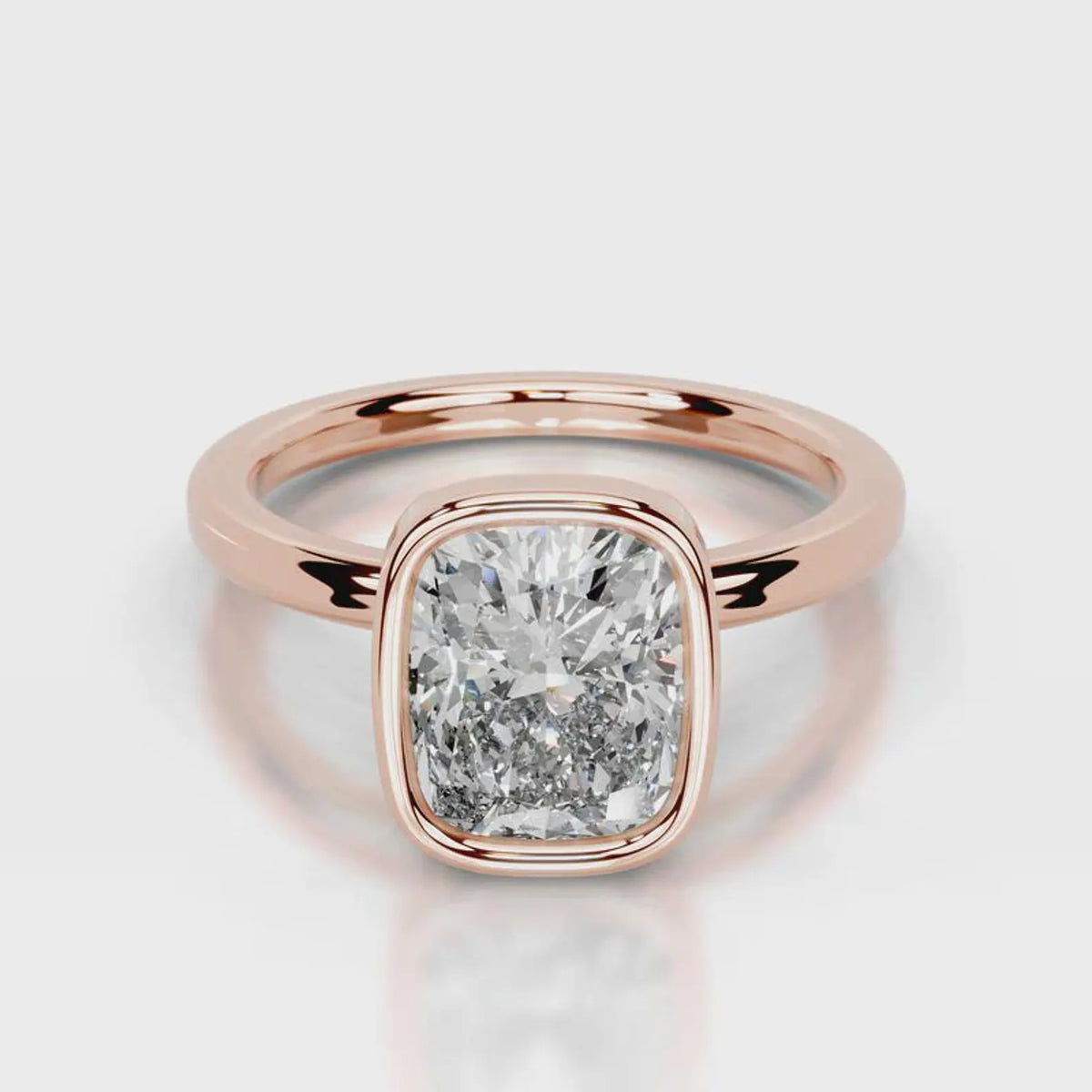 Direct front view of a 4 CT cushion cut lab diamond in a rose gold bezel setting.