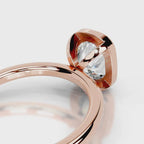Close-up view of the open gallery basket under a 4 CT cushion lab diamond in rose gold.