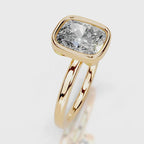 Three-quarter perspective of a 4 CT cushion lab grown diamond bezel ring in yellow gold.