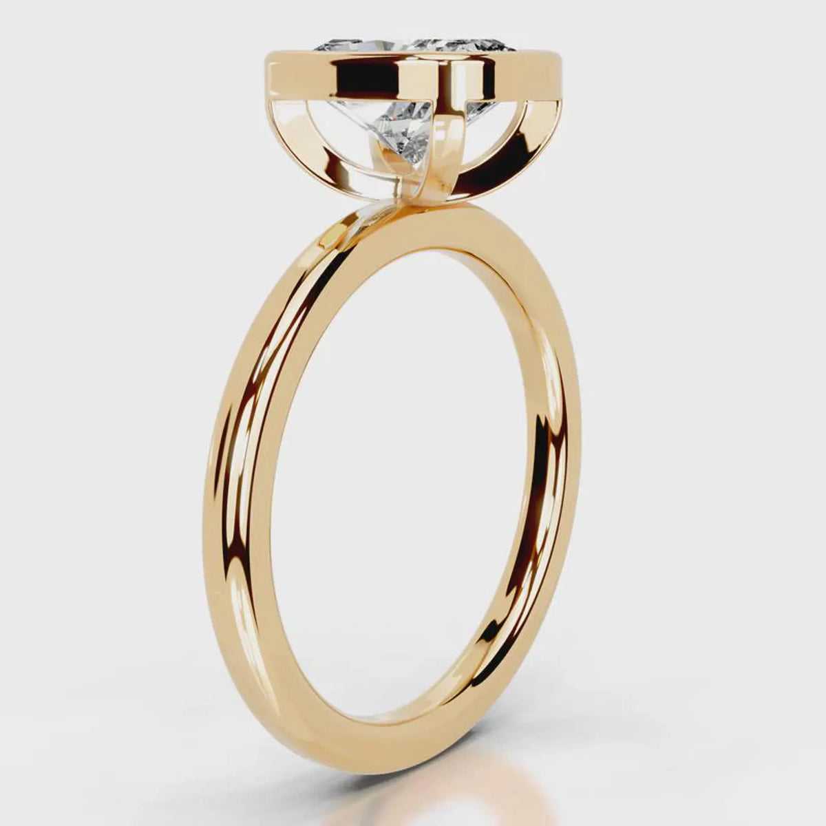 Side profile view of a 4 CT cushion cut lab grown diamond bezel ring in yellow gold.