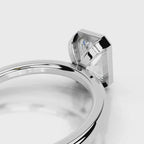 Close-up view of open gallery under-basket on 4 CT radiant lab diamond bezel ring in white gold.