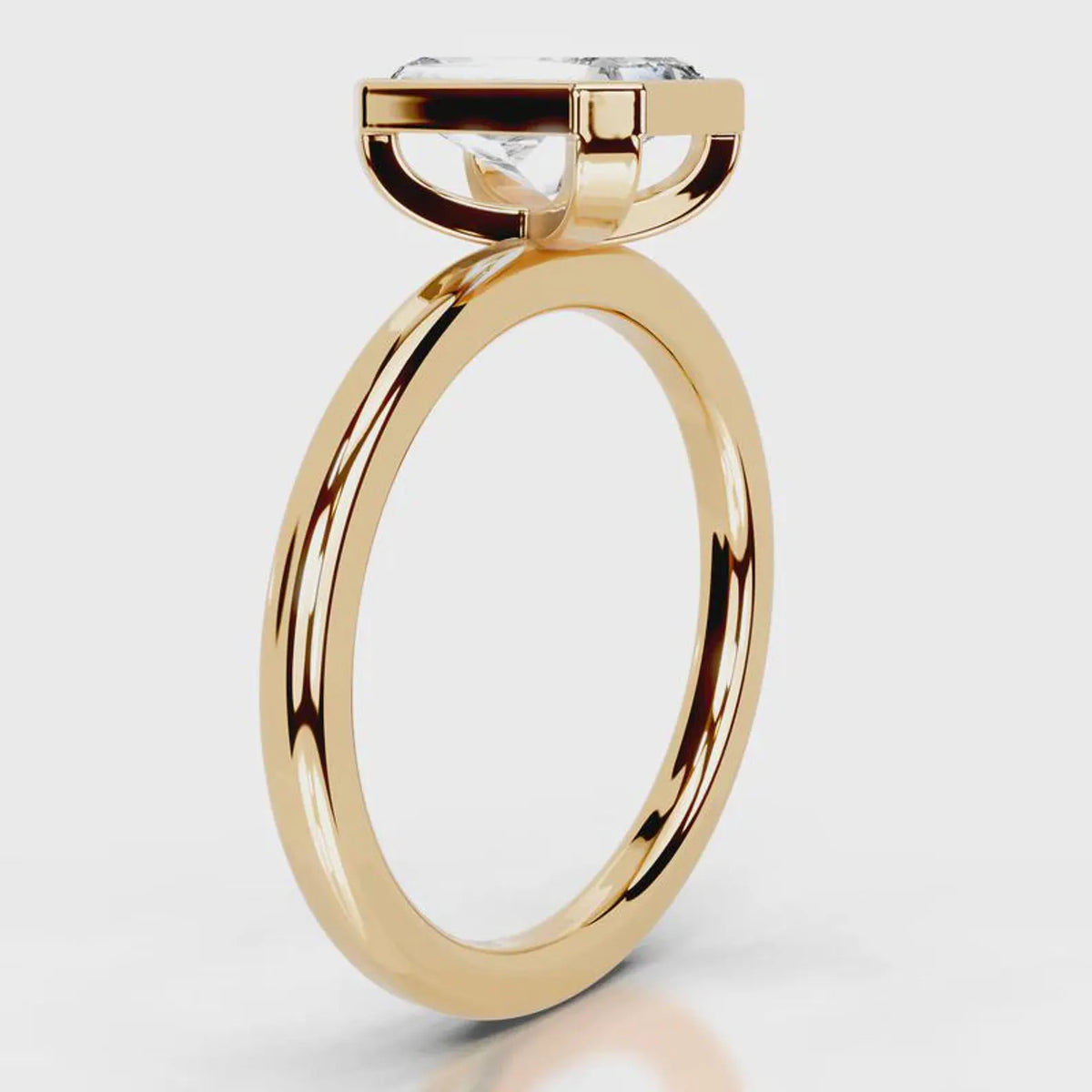 Side profile view of 4 CT radiant cut lab grown diamond bezel solitaire ring in yellow gold.