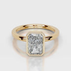 A yellow gold ring featuring a large, bezel-set rectangular emerald-cut diamond. The diamond is clear and does not contribute to the color mapping according to the schema rules, so the product color is determined solely by the gold metal band.