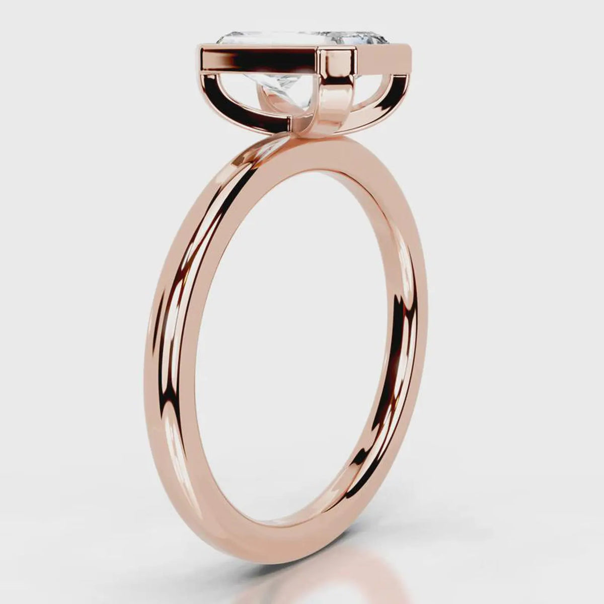 Side profile view of 4 CT radiant cut lab grown diamond bezel engagement ring in rose gold.