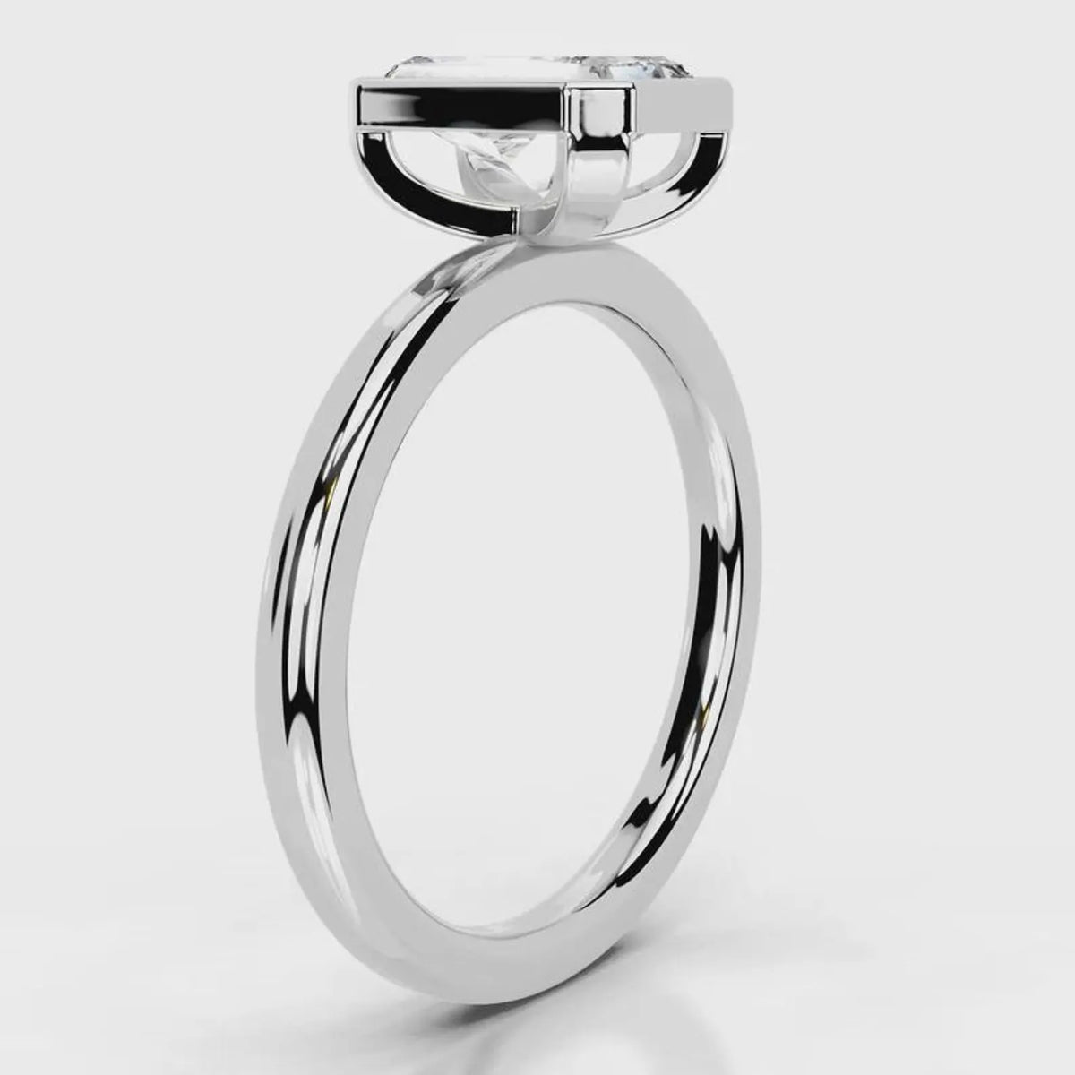 Side profile view of 4 CT radiant cut lab grown diamond bezel ring in white gold.