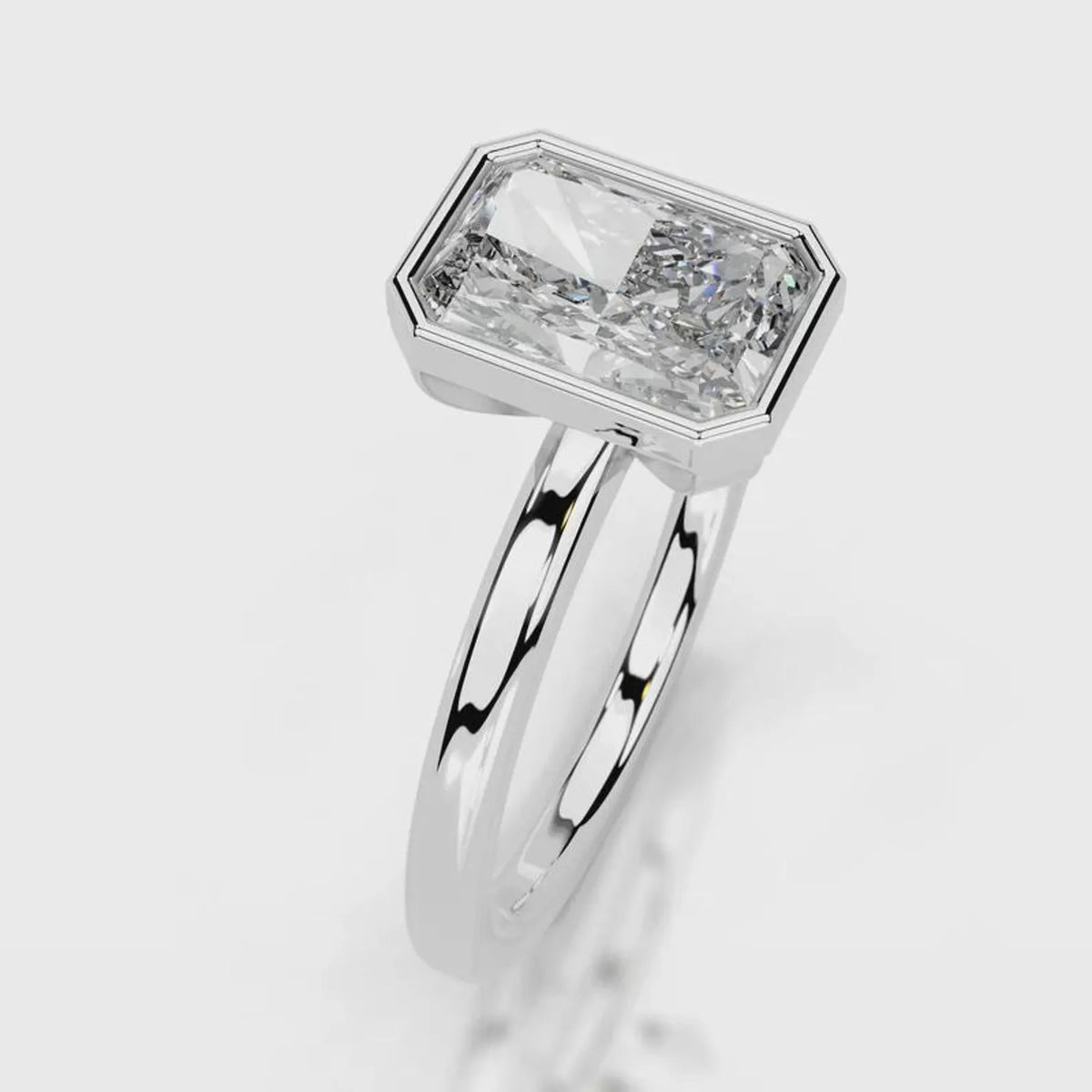 Angled perspective of 4 CT radiant cut lab diamond full bezel solitaire ring in white gold.