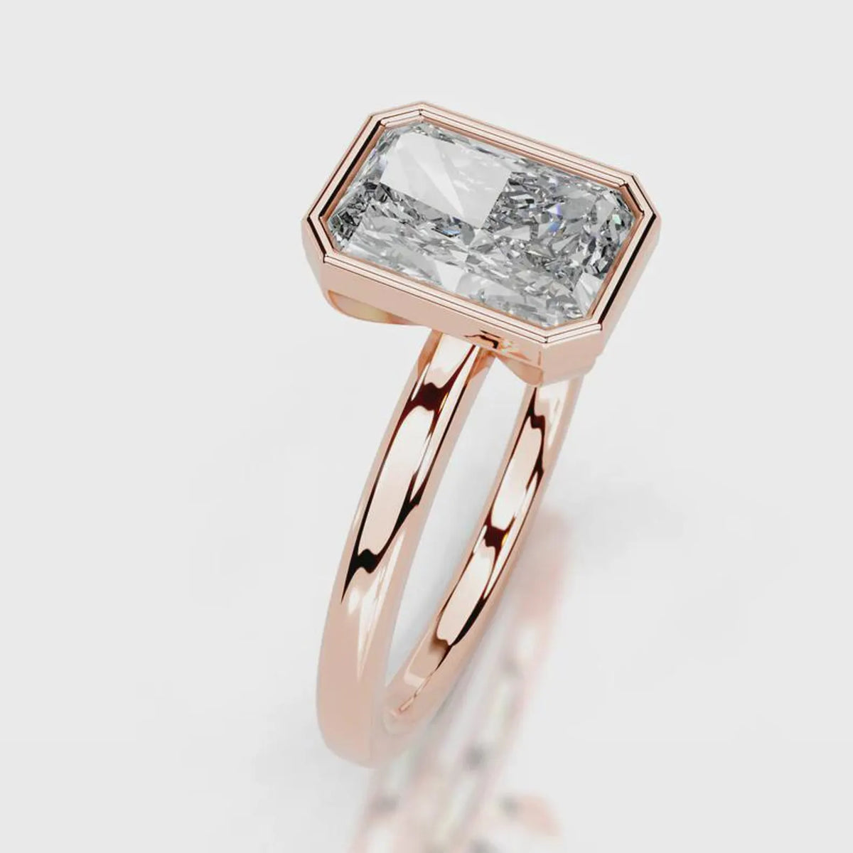 Three-quarter angle view of 4 CT radiant cut lab diamond bezel ring in rose gold.