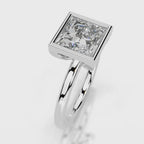 Side profile view of 4 CT princess cut lab grown diamond bezel engagement ring in white gold.