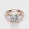Direct front view of 4 CT princess cut lab grown diamond bezel solitaire ring in rose gold.