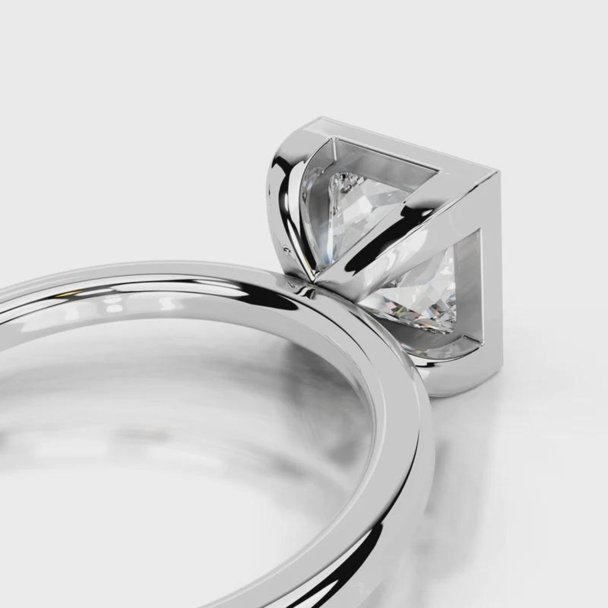 Direct front-facing view of 4 CT princess cut lab grown diamond bezel ring in white gold.
