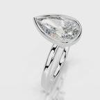 Angled top-down view of 4 CT pear cut lab grown diamond bezel engagement ring in white gold.