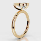 Side profile view of 4 CT pear cut lab diamond bezel engagement ring in yellow gold.