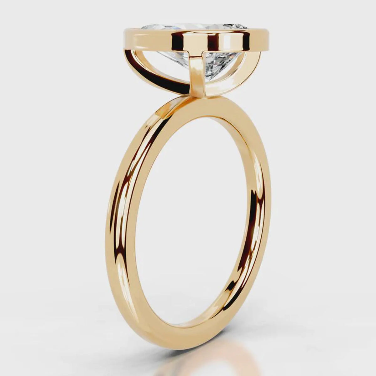 Side profile view of 4 CT pear cut lab diamond bezel engagement ring in yellow gold.