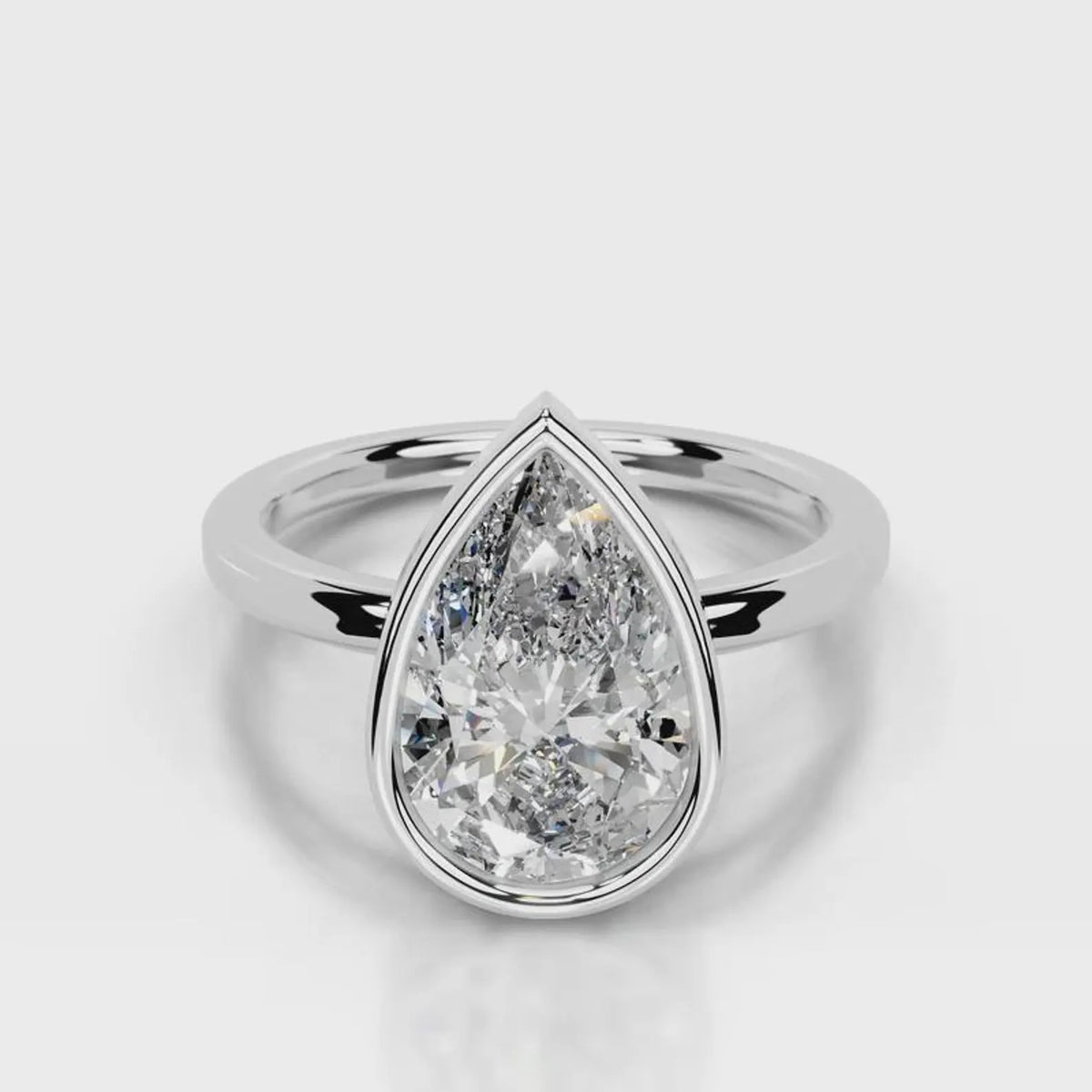 Direct top-down front view of 4 CT pear cut lab grown diamond bezel ring in white gold.