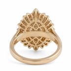 Underside view of a vintage sunburst halo ring showing the intricate gold filigree undergallery supporting a 3 carat marquise lab diamond.