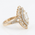 Side profile view of a yellow gold vintage marquise lab diamond halo ring featuring a split pave shank with milgrain edges.