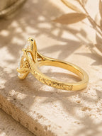 Three-quarter angle of a 4 carat marquise diamond solitaire ring displaying hand-carved milgrain band details.