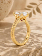 High-angle side view of a cathedral marquise lab diamond engagement ring with engraved band and surprise hidden gemstone.
