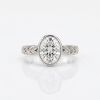 Front view of a 3 carat oval lab grown diamond bezel ring in white gold featuring vintage leaf scrollwork.