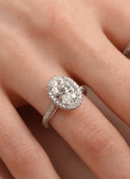 On-hand view of a 3 CT oval cut lab grown diamond engagement ring with micro-pavé halo and pavé band.