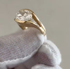 Side profile angle of a 4 carat East-West oval lab grown diamond bezel ring in 18K yellow gold with open gallery.