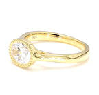 Angled top-side view of a 2 carat East-West oval lab grown diamond ring with milgrain bezel setting in yellow gold.