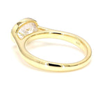 Perspective side view showing the inner band and horizontal oval diamond in a beaded bezel setting.