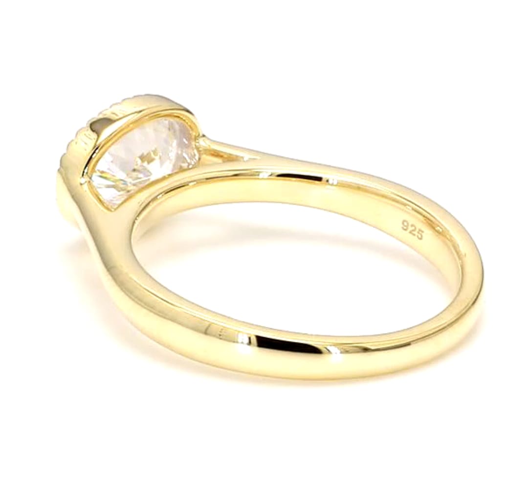 Perspective side view showing the inner band and horizontal oval diamond in a beaded bezel setting.