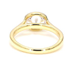 Side view under the setting showing the open gallery structure of an East-West oval lab diamond bezel ring.