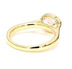 Back angle view of a yellow gold 2 ct horizontal oval lab diamond ring with a polished shank.