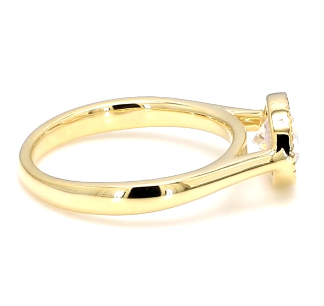 Side perspective view showing the smooth yellow gold band and bezel setting of a 2 ct oval lab diamond ring.
