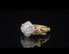 Angled view of 2 CT round lab grown diamond vintage floral engagement ring in yellow gold.