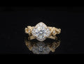 High-detail angled shot of 2 CT round brilliant center diamond and milgrain halo.