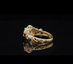 Angled side view of botanical leaf scrollwork shank on 2 CT round diamond ring.