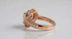 Side profile view showing filigree gallery architectural detail and side pearls in rose gold.