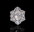 Top-down view of 3 CT oval lab grown diamond ring with 6-petal floral starburst halo.