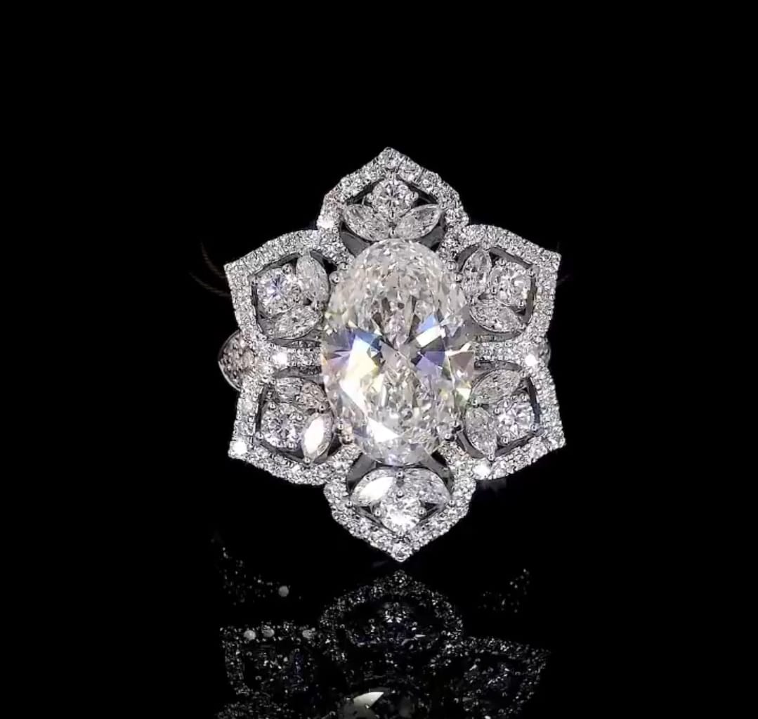 Top-down view of 3 CT oval lab grown diamond ring with 6-petal floral starburst halo.