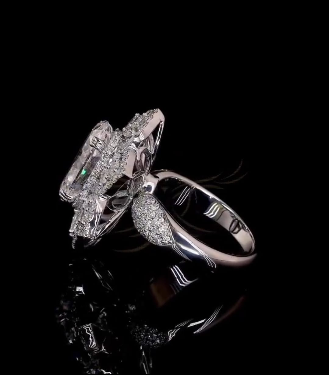 Side angle view of 3 CT oval diamond ring showing pave shoulders and elevated basket setting.