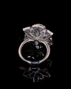 Bottom profile view showing petal-shaped openwork under-gallery architecture on white gold band.