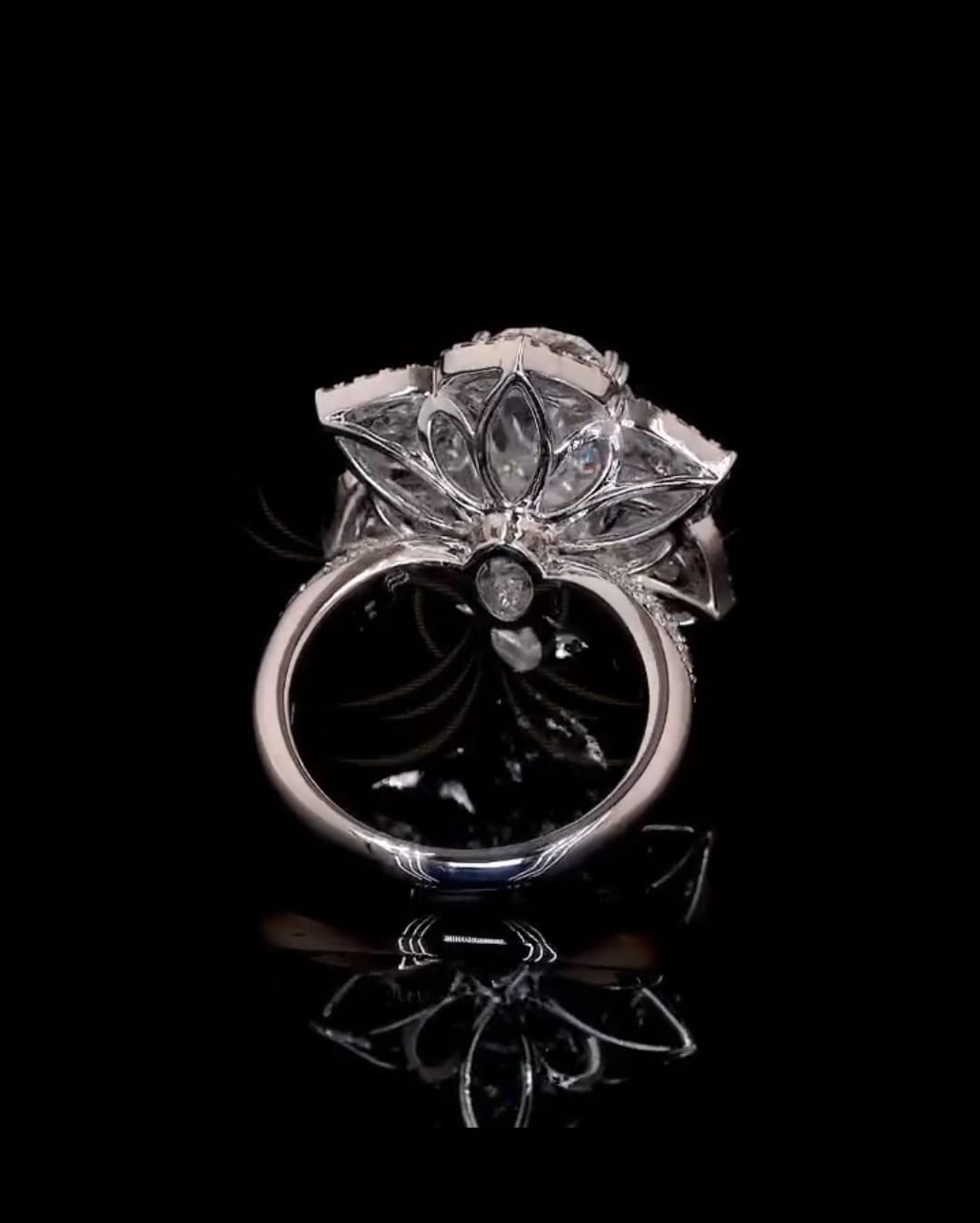 Bottom profile view showing petal-shaped openwork under-gallery architecture on white gold band.