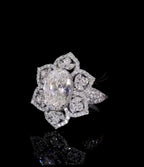 Three-quarter view of 3 CT oval center diamond and marquise petal halo accents.