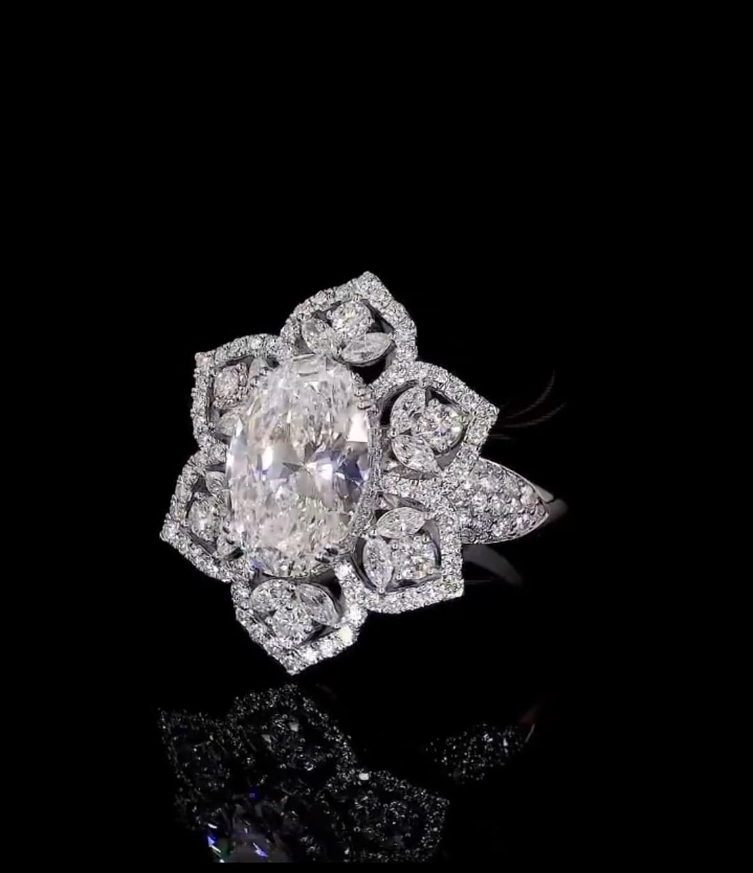 Three-quarter view of 3 CT oval center diamond and marquise petal halo accents.